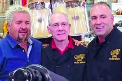 Guy Fieri standing with two gentleman in Robbinsville NJ