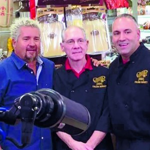 Guy Fieri standing with two gentleman in Robbinsville NJ.