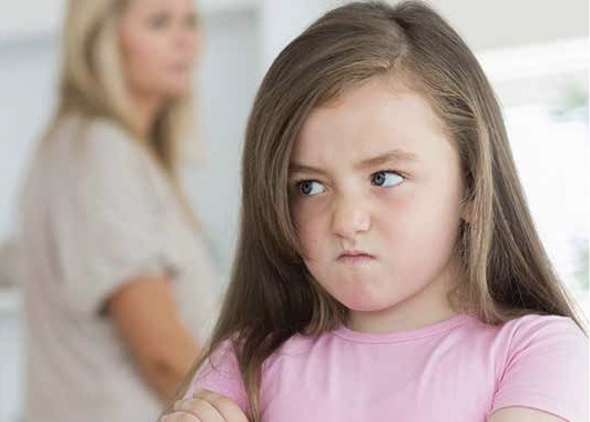 A daughter who looks very upset at her mother in the background