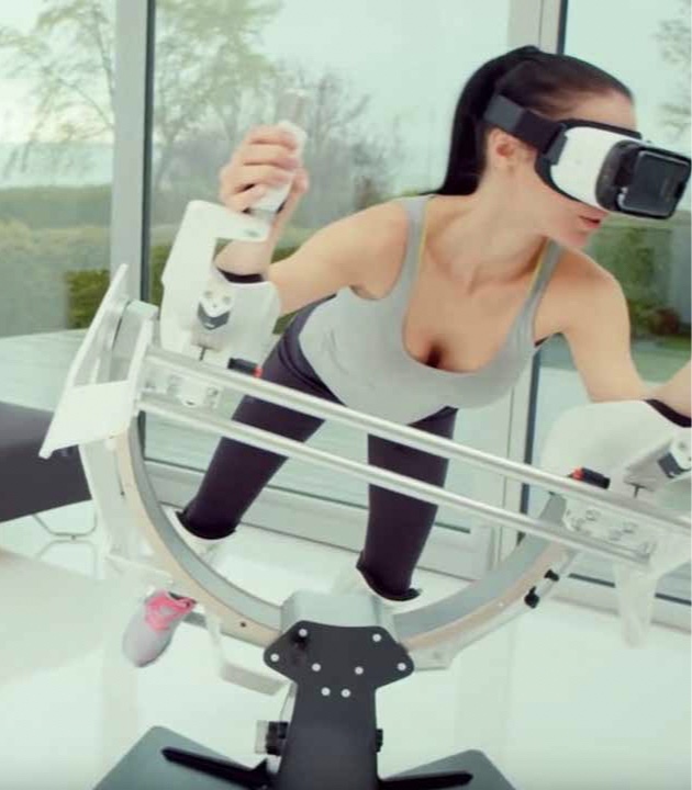A women using a virtual reality headset while on a fitness devise working out