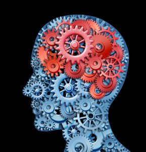 A picture of a head, filled with many gears, and red gears where the brain would be