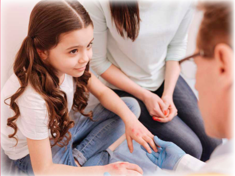 A doctor looking at a girl next to her parent, speaking about diabetes
