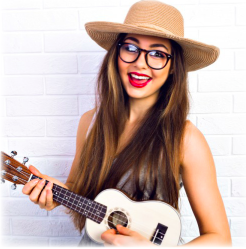 A women in a hat strumming a ukulele
