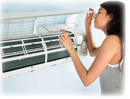A lady looking at her air conditioning filters