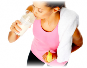 A lady post workout drinking a smoothie and eating a banana
