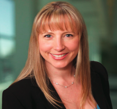 A headshot of a lady wearing a black jacket