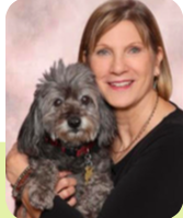 A women sitting with her dog in her arms