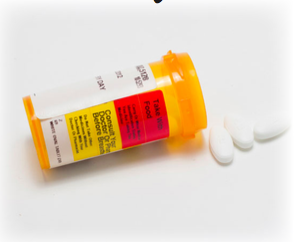An open bottle of pills with a few spilled out