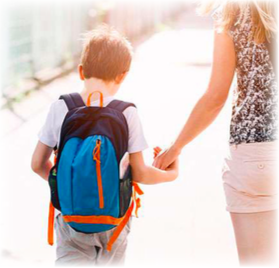 A boy wearing a backpack holding his mothers hand
