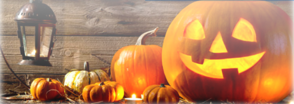 Jackolanterns and pumpkins sitting next to a floating lantern