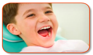 A closeup of a child at the dentists office with a big smile