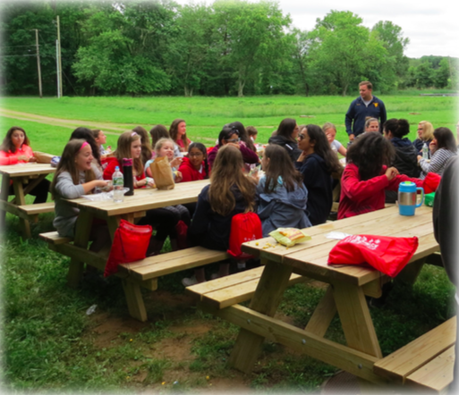 Troop 116 sitting at tables and eating lunch together