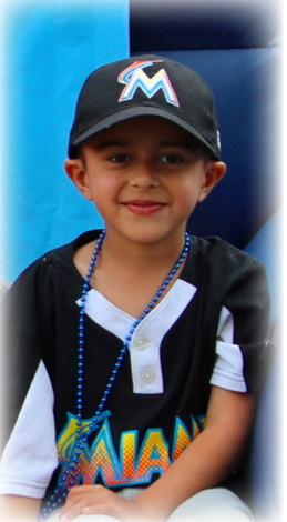 A young boy, wearing a cool black hat, shirt, and a blue beaded necklace