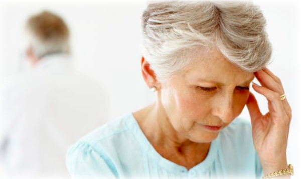 An older lady holding her head in confusion or pain
