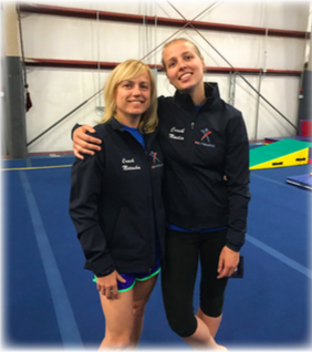 Two women standing next to each other in what looks like a gymnastics gym