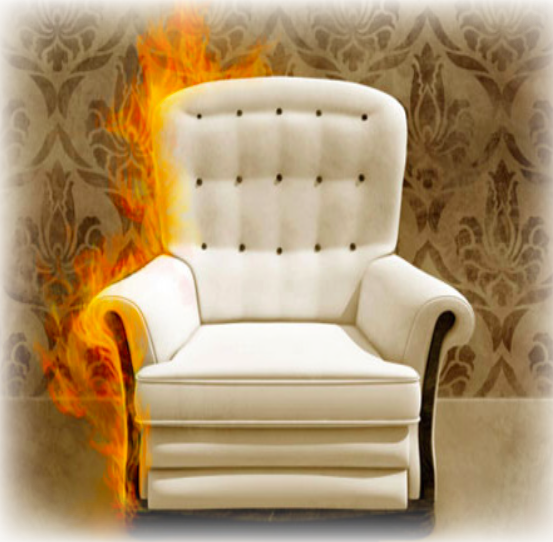 A chair that is half on fire, with a decadent wallpaper in the background