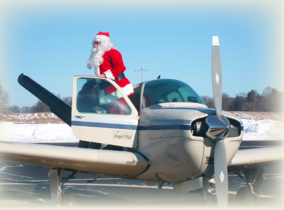 Santa coming out of a personal sized aircraft