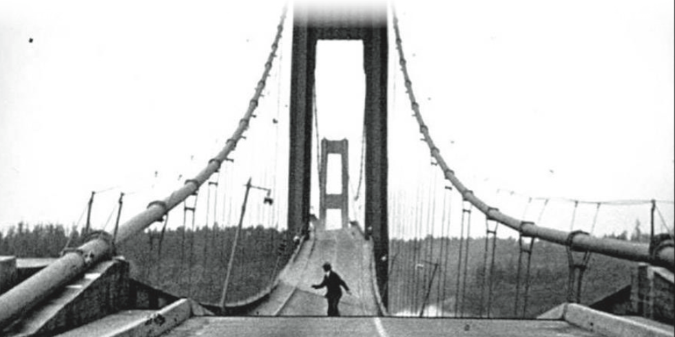 A black & white photo of a bridge flexing in the wind