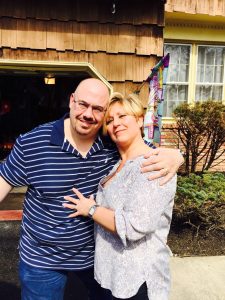 Lori & Vincent Cusick, in front of their home