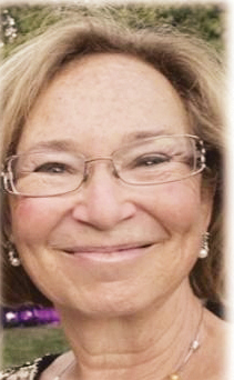 A closeup photo of a women with short hair and glasses