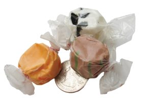 Some saltwater taffy next to a quarter for scale reference