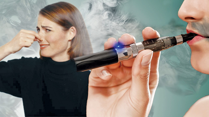 Someone holding their nose closed while someone hits an e-cigarette near them