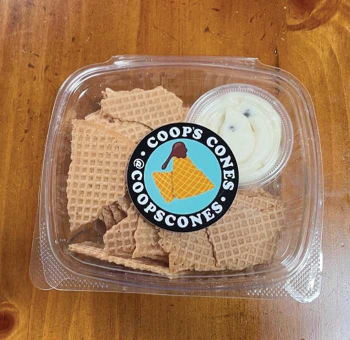 A box of Coop's Cones, with a dipping sauce inside