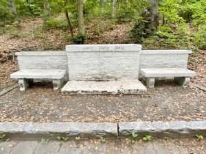 A Tombstone In between two benches made out of the same material as the stone