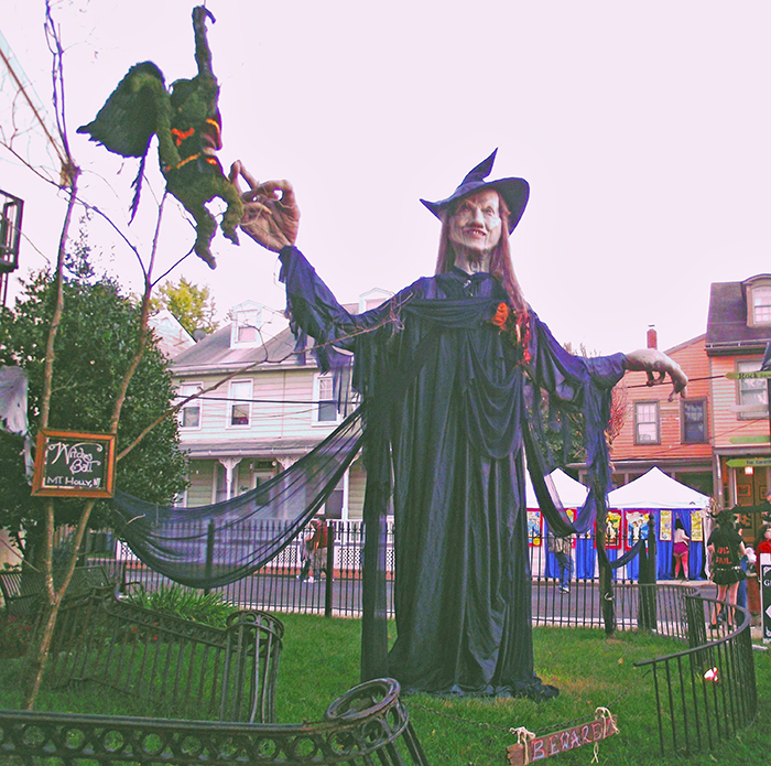 A giant witch wearing purple and black tattered clothing