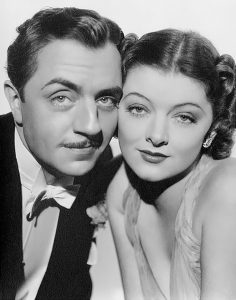 A black and white photo of an esteemed looking couple, gazing back at us into the camera