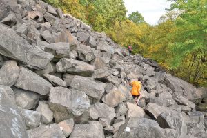 The Giant Stairs, made up of huge pieces of rocks, with someone climbing around them.