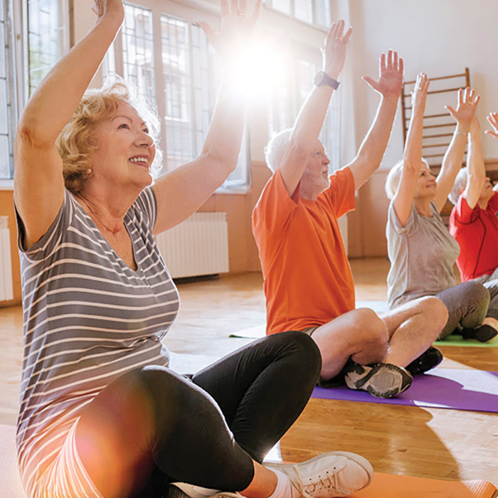 A group of older individuals participating in yoga in a studio!