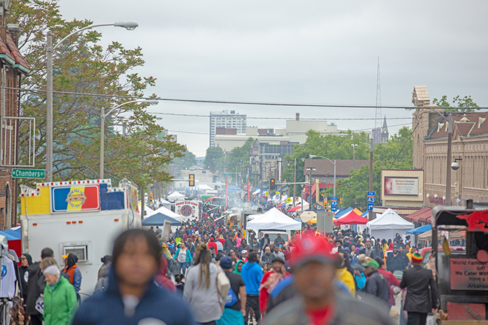A picture of a crowded city on Juneteenth. With some blurred faces in the foreground